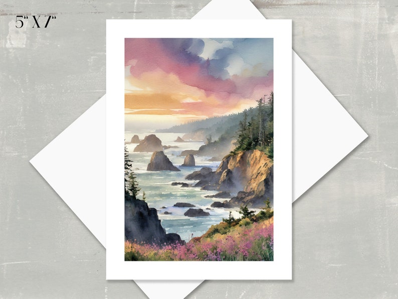 5" X 7" note card watercolor featuring a sunset over a rocky coastline.  The sky is a blend of pink, orange, and purple hues. Dark green trees and cliffs are visible, with dark rocks and ocean waves in the foreground.  Wildflowers are depicted along the cliff edge. The overall color palette is warm and inviting, creating a serene coastal scene.