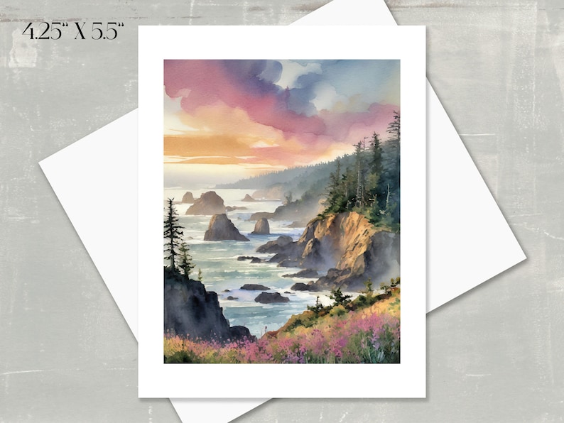 A watercolor of the sun setting over the rocky Oregon coastline.  The sky is a blend of pink, purple, and orange hues. Dark green evergreen trees line the cliffs.  The ocean is a calm blue-green.  Wildflowers in shades of pink and purple are in the foreground. The card measures 4.25" x 5.5".
