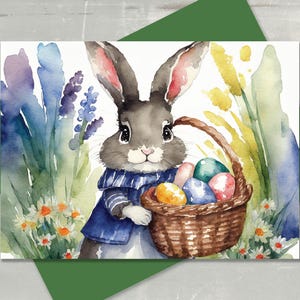 May include: A watercolor painting of a gray bunny holding a basket of colorful Easter eggs. The bunny is wearing a blue and white striped shirt and is surrounded by green and yellow flowers.