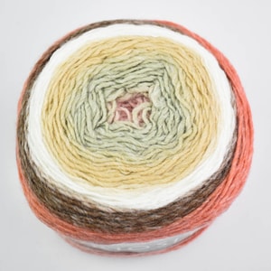 May include: A ball of yarn in a gradient of colours, featuring brown, white, yellow, green, and peach hues. The yarn is wound in concentric circles, creating a textured appearance. Suitable for knitting and crochet projects, this yarn offers a range of tones.