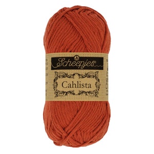 May include: A ball of orange cotton yarn with a brown label that reads "Scheepjes Cahlista".