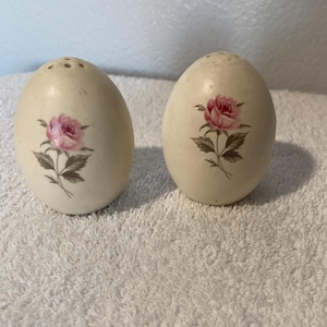 Egg-shaped salt and pepper shakers with pink rose