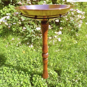 May include: A white ceramic mug with a black handle and the text "But First, Coffee" in a black, bold font. The mug is on a white surface.