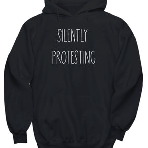 May include: Black hooded sweatshirt with the text "SILENTLY PROTESTING" in white.