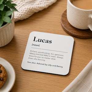 Pode incluir: Um porta-copos quadrado branco com texto preto que diz Lucas [noun], Brilliant, goodlooking, fun, generous. Makes the best BBQ in town. Always there for you no matter what. Does silly dancing. See also: Adored by Lilly and Benny.