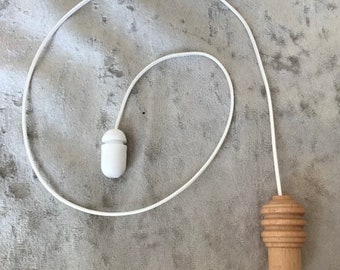 Wood light pull with white pull cord and cord connector