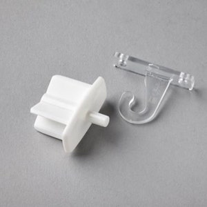 May include: White plastic curtain rod end cap with a small white plastic pin and a clear plastic curtain rod hook.