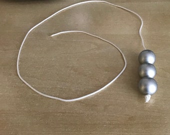 Silver bead style light pull with pull cord and cord connector