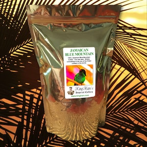 May include: A gold foil bag of Jamaican Blue Mountain coffee with a hummingbird on the label. The label reads "Jamaican Blue Mountain 100% Jamaican Blue Mountain Coffee. The real deal. Widely considered to be one of the finest coffees in the world. King Hari's Imperial Coffees www.kingharv.com"