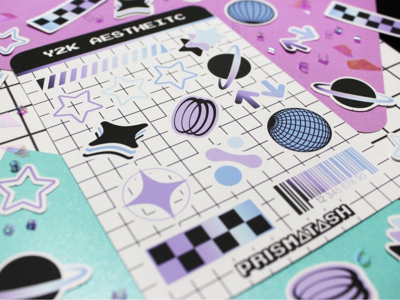 May include: A sheet of stickers with a Y2K aesthetic theme. The stickers feature a variety of designs, including stars, planets, and geometric shapes. The stickers are printed on white paper with a grid pattern. The text "Y2K AESTHETIC" and "PRISMATASH" are printed on the sheet.