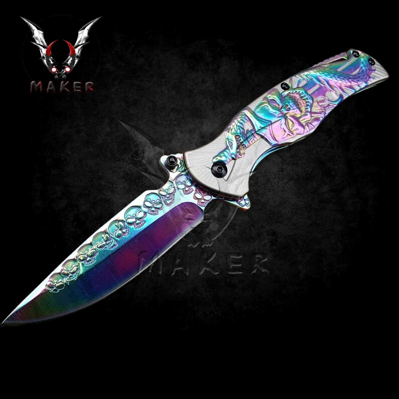 May include: A rainbow-coloured folding knife with a skull design on the blade and a dragon design on the handle.