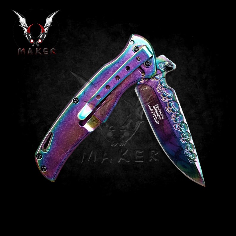 May include: A rainbow-coloured folding knife with a skull design on the blade. The blade is engraved with "DS-A3488 Stainless USA Design".