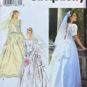 May include: Simplicity pattern number 8240 for a wedding dress. The pattern includes three different styles of wedding dresses. The first dress is a lace dress with a long train. The second dress is a satin dress with a long train. The third dress is a satin dress with a shorter train.