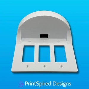 May include: A white, 3-gang light switch cover with a curved top and three rectangular openings. The cover has a small, black rectangular opening at the top. The text "PrintSpired Designs" is at the bottom.