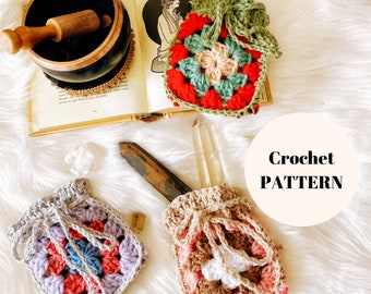 May include: Two crocheted bags with a granny square design. One bag is purple, pink, and blue. The other bag is brown, pink, and white. The bags are sitting on a white fluffy surface. Crochet Pattern.