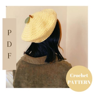 May include: A yellow crochet beret with a green leaf detail. The beret is worn by a person with dark hair and a brown corduroy jacket. The text "Crochet PATTERN" is visible in the lower right corner of the image.