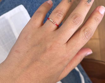 Red string ring with gold