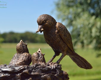 Bronze sculpture of a feeding bird