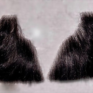 May include: Two dark brown, bushy, fake mustaches. Each mustache is a separate piece, with a curved shape and a textured appearance. The background is a light gray color.