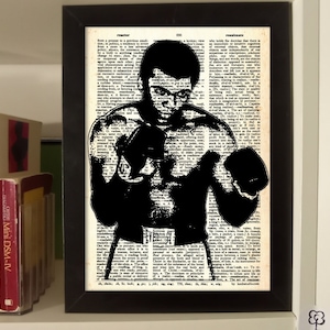 Muhammad Ali. Cassius Clay. Amerykański bokser. Największy. Sztuka słownikowa. Wydruk artystyczny boksu. Sztuka ścienna sportowa. Wydruk na prawdziwej stronie słownika.