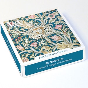 May include: A box of notecards with a teal floral design. The box features the text "Arts & Crafts Flowers" and "20 Notecards". Each card has 4 designs with envelopes. The floral pattern includes pink, white, and gold accents.
