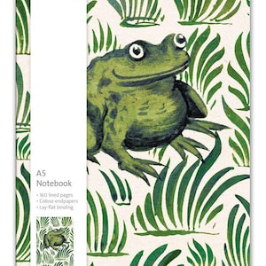 May include: An A5 notebook featuring a green frog illustration on a cream background with green foliage. The cover includes a white vertical band with the text V&A, A5 Notebook, 160 lined pages, Colour endpapers, Lay-flat binding, and design details.