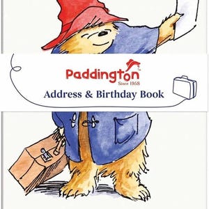 May include: A white address and birthday book featuring a watercolour illustration of Paddington Bear wearing a red hat and blue coat, holding a suitcase. The text reads Address & Birthday Book and Paddington Since 1958 with a small suitcase icon.