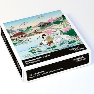 May include: A square box of 20 notecards titled Japanese Waterscapes from The British Museum. The box features a colourful illustration of cranes, lotus flowers, and a building by a lake. The black label text reads 20 Notecards, 5 each of 4 designs with envelopes.