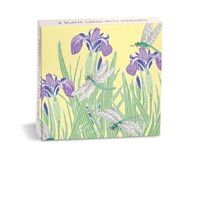 May include: A square box set containing 8 blank cards with envelopes. The packaging features a pale yellow background with a graphic illustration of purple iris flowers, green foliage, and white dragonflies with green bodies and wings.