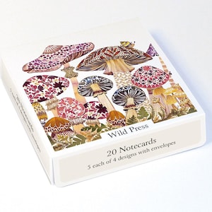 May include: A white box containing 20 notecards with envelopes, featuring a colourful illustration of various mushrooms with intricate patterns. The box is labelled Wild Press and states 20 Notecards, 5 each of 4 designs with envelopes.