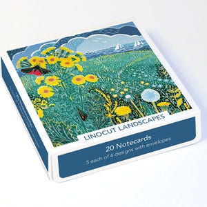 May include: A box of notecards with a linocut landscape design. The image shows a field of yellow flowers, butterflies, and a seascape with sailboats. The box has the text "LINOCUT LANDSCAPES" and "20 Notecards".