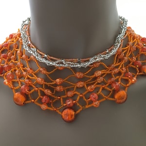 Indian glass beaded necklace in fire orange and clear beading is a one of a kind with a metal magnet clasp.