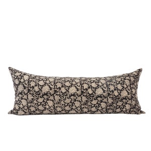 May include: A black and white floral patterned lumbar pillow. The pillow is rectangular and has a subtle sheen.