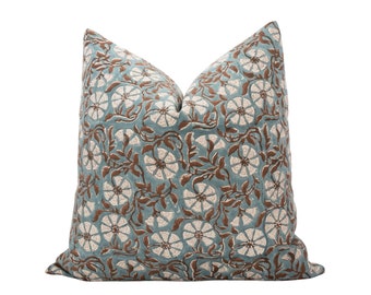 May include: A blue and brown patterned throw pillow with a floral design.