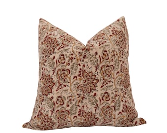 May include: A decorative pillow with a floral pattern in shades of red, green, and beige. The pillow is made of a soft, textured fabric.