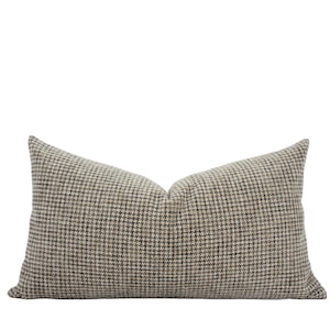 May include: A brown and beige patterned lumbar cushion with a subtle houndstooth design.
