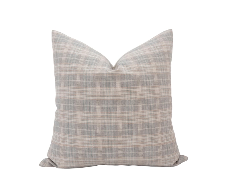 May include: A soft, gray and pink plaid throw pillow with a square shape.