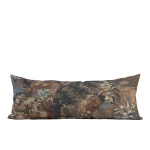 A long, rectangular decorative pillow with a tapestry-like design. The pillow features a detailed pattern of trees, foliage, and hints of blue and brown hues. The pillow is designed for decorative purposes.
