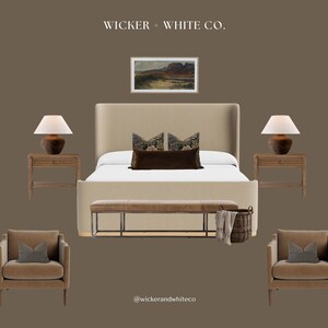 May include: A bedroom scene featuring a beige upholstered bed with decorative pillows, flanked by wooden nightstands with lamps. Two armchairs with patterned pillows and a bench are in front of the bed. A landscape painting hangs above the bed.