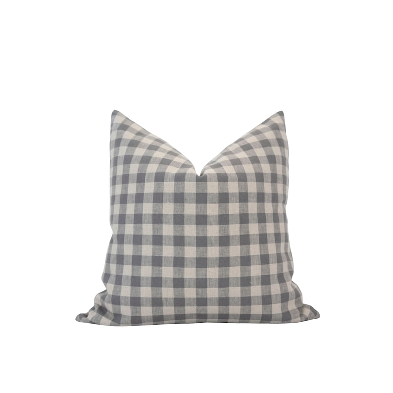 May include: A gray and white gingham pillow with a square pattern.