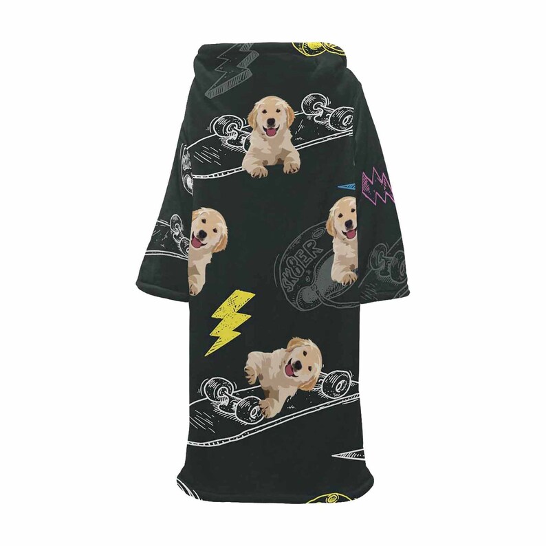 May include: Black wearable blanket featuring a repeating pattern of golden retriever puppies, skateboards, and yellow lightning bolts. The blanket has a hood and sleeves, perfect for lounging. The word "SK8ER" is visible on the skateboard.