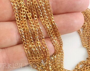 May include: Close-up of multiple strands of gold-colored chain. The chains are made of small, interlocking links, creating a delicate and textured appearance. The chains are arranged in a layered fashion, suggesting they could be used for necklaces or other jewelry.