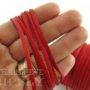 May include: Red leather cord, approximately 3mm wide, wound around a spool. The cord is soft and supple, ideal for crafting jewellery, bracelets, and other projects.