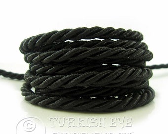 May include: Black twisted cord, a type of cording used for crafts and home decor projects.