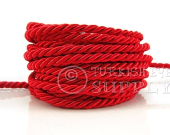 May include: A spool of red twisted cord, perfect for crafting and decorating.