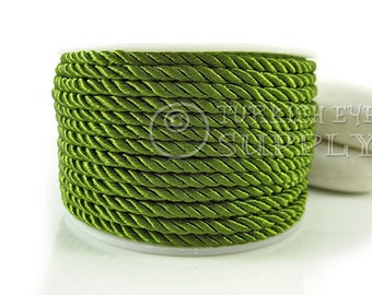 May include: A spool of green satin cord. The cord is twisted and has a smooth, shiny finish.
