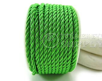May include: A spool of bright green twisted cord. The cord is made of a soft, silky material and is perfect for crafting and decorating.