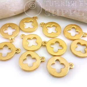 May include: Ten gold-tone metal charms with a circular shape and a four-leaf clover cutout design. Each charm has a small loop for attaching to jewelry or other crafts.