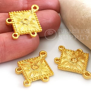 May include: Three gold-toned metal square connectors with four loops. Each connector features a raised floral design.
