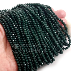 May include: A handful of dark green faceted beads. The beads are strung together, creating multiple strands. The beads have a shiny, reflective surface. The image includes the text "TURKISH EYE SUPPLY".